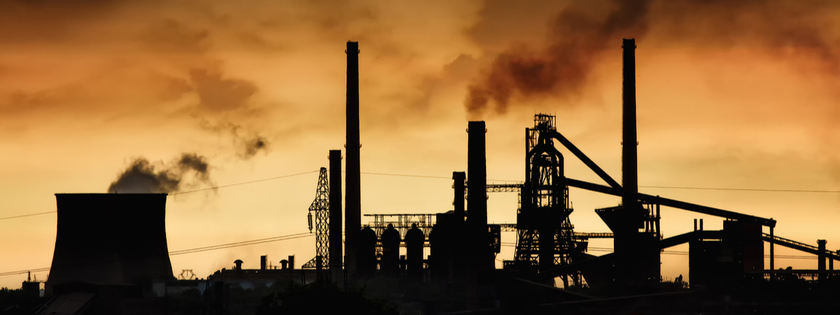 Smokestack-in-factory-with-yellow-sky-and-clouds.-Industrial-pollution.